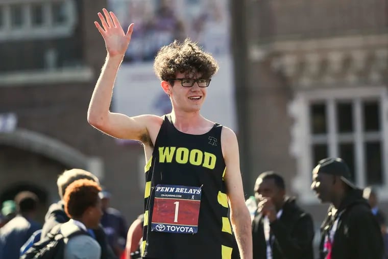Gary Martin of Archbishop Wood waving after finishing first in the High School Boys' Mile Run Championship at Franklin Field in Philadelphia on Friday, April 29, 2022. Martin broke the Penn Relays record for the mile run.
