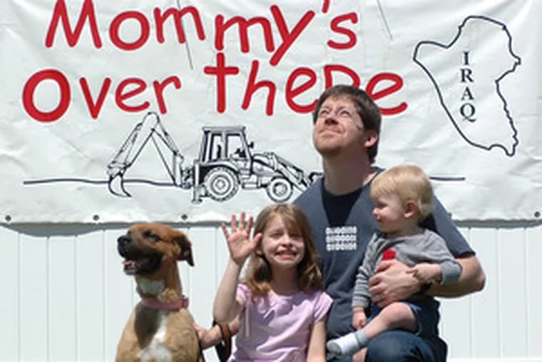 Retired Air Force pilot Jonathan Allain is Mr. Mom with daughter Abigail, 7, and son Balen, 14 months, and their dog Jazz at their Lumberton home while his wife, Michel, finishes her second tour of duty in Iraq.