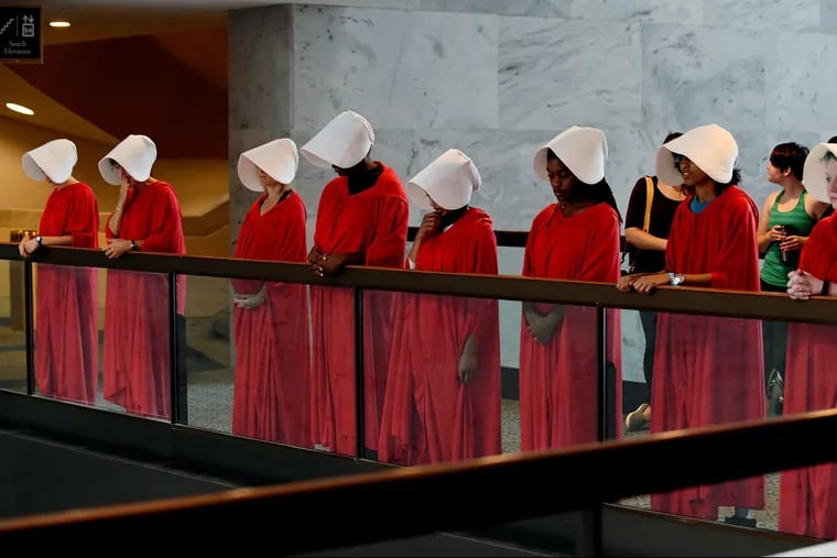 Protesters dressed as handmaids from "The Handmaid's Tale" protest outside the hearing room where Supreme Court nominee Judge Brett Kavanaugh testifies before the Senate Judiciary Committee during his Supreme Court confirmation hearing in the Hart Senate Office Building on Capitol Hill Sept. 4, 2018 in Washington, D.C.