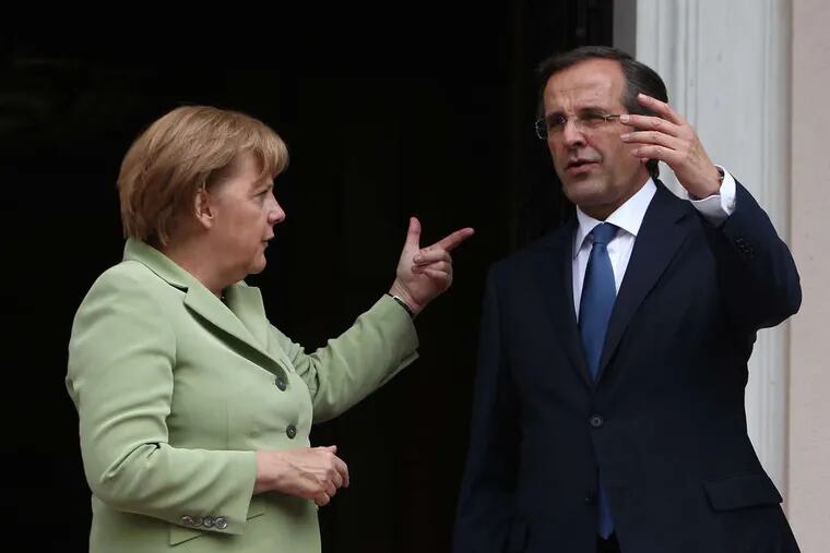 German Chancellor Angela Merkel and Greek Prime Minister Antonis Samaras before their meeting in Athens. Her first visit since Greece's debt crisis erupted three years ago attracted 50,000 demonstrators. &quot;I hope and wish that Greece remains a member of the eurozone,&quot; she said. &quot;As partners, we are working hard to achieve that.&quot; THANASSIS STAVRAKIS / AP, Pool