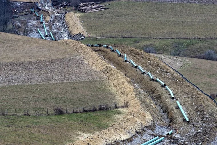 CAPTION CORRECTION – CORRECTS DIAMETER OF PIPE Twenty-inch epoxy-coated pipes being installed on the Mariner East 2 pipeline in the rolling hills of Washington County last February. The pipeline, parts of which run through Delaware and Chester counties, is the source of much concern among residents.