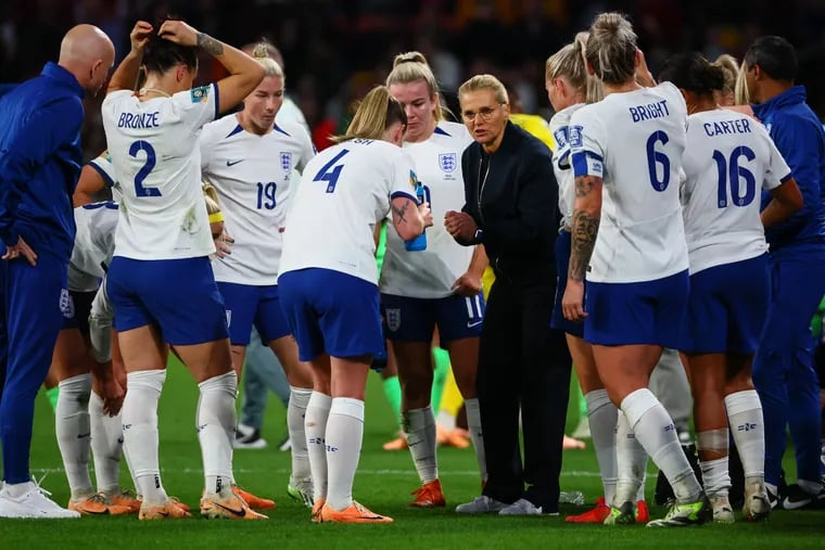 England manager Sarina Wiegman (center) speaks with her players during their World Cup semifinal win over Australia. Wiegman and Lucy Bronze (second from left) played college soccer at North Carolina and are still close to the program.