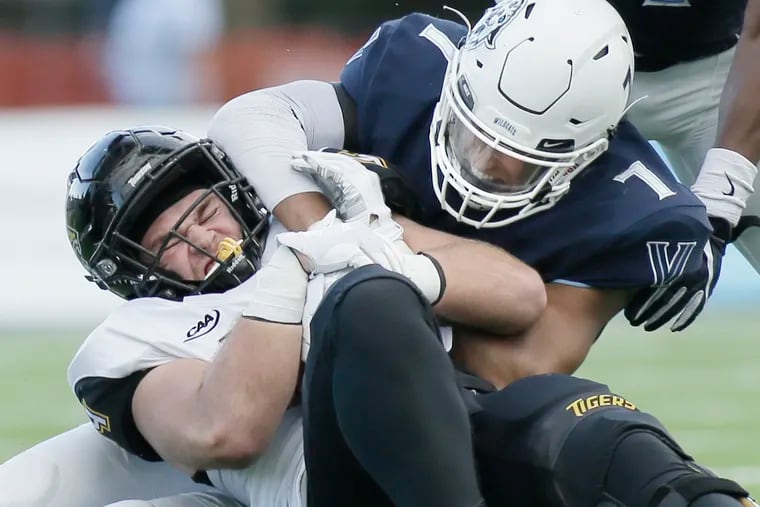 Towson's # 44 Zach Heron is stopped by Villanova's # 7 Julian Williams in the 3rd quarter of the Towson at Villanova University football game on September 15, 2018, ELIZABETH ROBERTSON / Staff Photographer