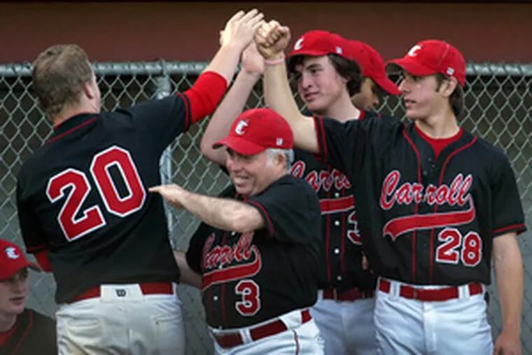 Carroll&#0039;s Chris Lisowski (left) is congratulated by teammates after his RBI single in seventh inning.