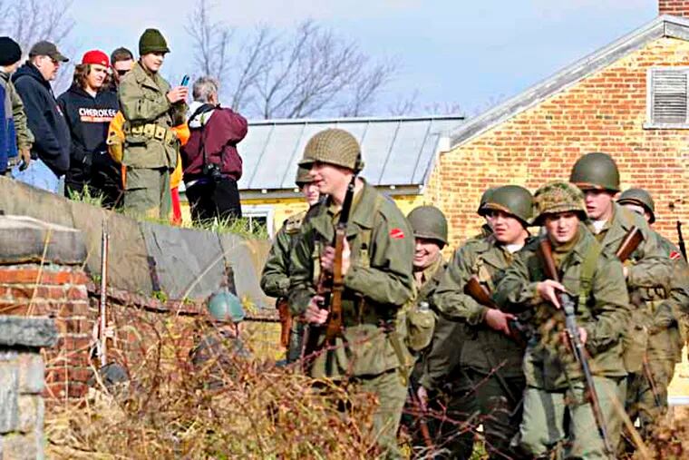 On lookers watch as World War II reenactors participate in a reenaction of the battle of Hurtgen Forest at Ft. Mifflin on the occasion of The attack on Pearl Harbor 72 years ago. (RON TARVER / Staff Photographer ) December 7,  2013