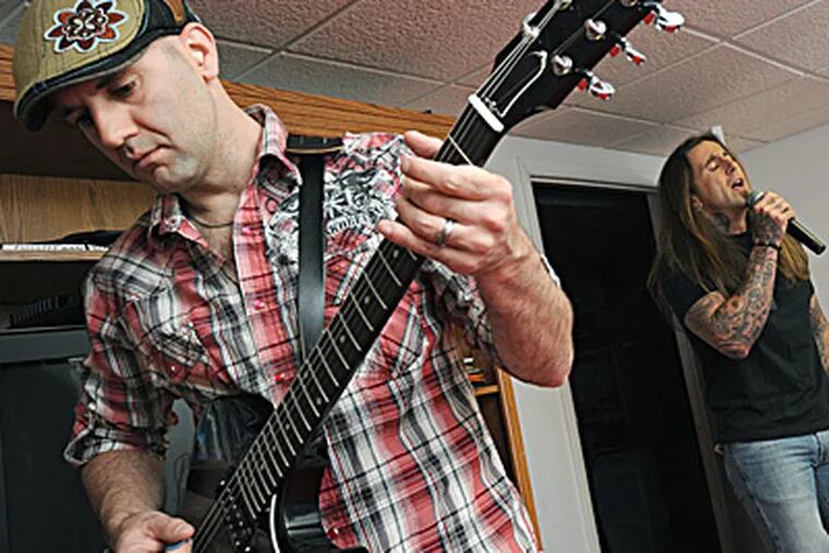 AmBlur guitarist Rich Palumbo and his brother, vocalist Lou Palumbo, practice for the Rockin' Docs show. APRIL SAUL / Staff Photographer