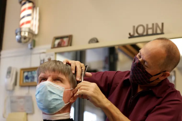 John Troncelliti working on customer Ken Henderson. He intends to leave later this month, but hopes to sell the shop. "My philosophy is to quit while you’re ahead," he wrote in a message to customers. He hopes to open a concierge barber business.