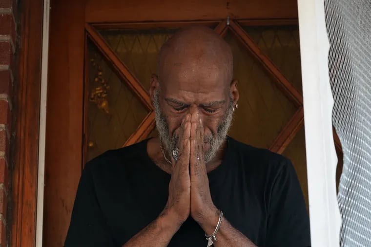 Neighbor Ivan escobar says a prayer for the victims of a shooting on the 2600 block of Carroll Street, where one man was killed while five others were injured in a shooting in Southwest Philadelphia Sunday night, in Philadelphia, July 29, 2019.
