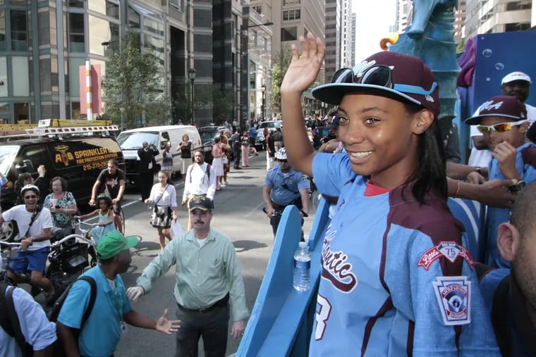 Mo'ne Davis waves to the crowds during the parade for the Taney Dragons in Phila. on Aug. 27, 2014.
