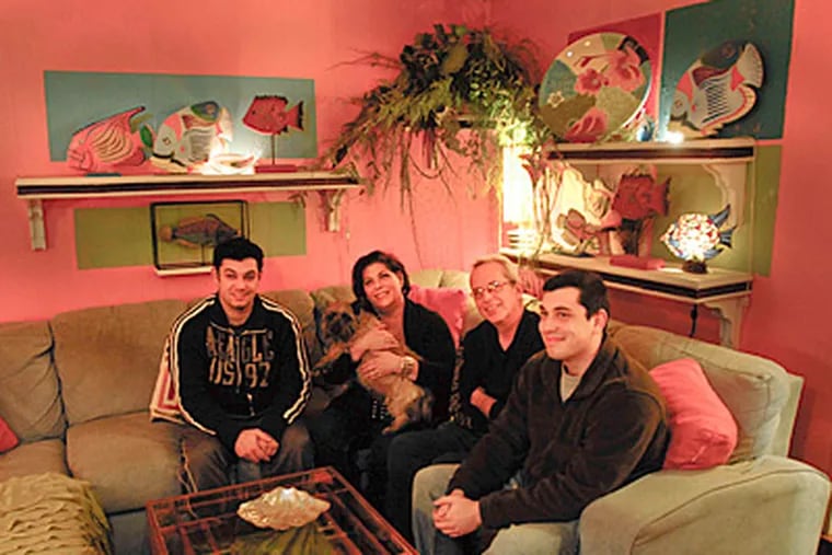 The Moretti family (from left to right) Josh, Christine, Al and Jeremy sit in the brightly colored living room of their Somerton home. (Ron Tarver / Staff Photographer)