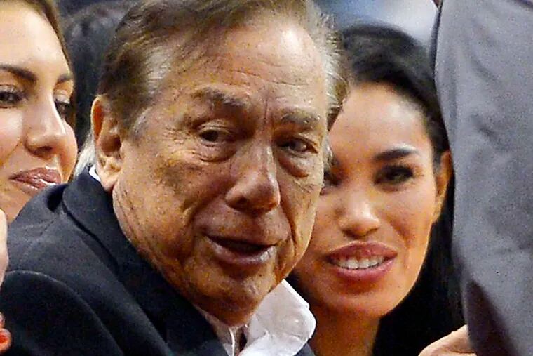 Sterling with frequent guest V. Stiviano at a Clippers game.