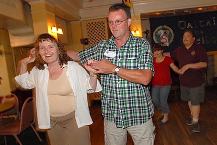Anne Matias and Phil Murray of Hamilton, N.J., dance Saturday at the Irish Center at the Commodore Barry Club in Mount Airy. (April Saul / Staff)