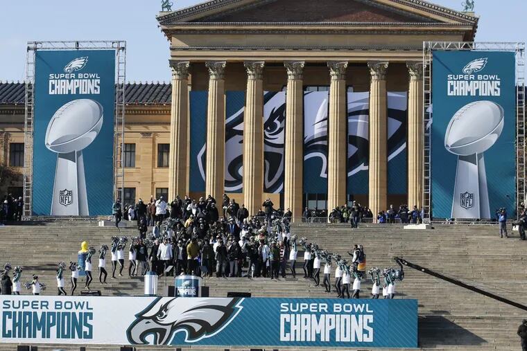 Member of the Eagles march down the steps of the Philadelphia Museum of Art during the Super Bowl LII victory celebration on Thursday, February 8, 2018. YONG KIM / Staff Photographer