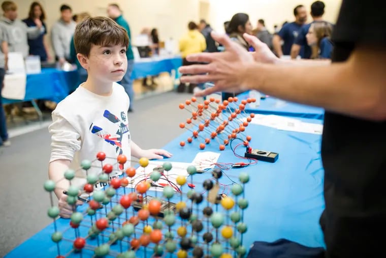 Raid Usher, 8, listens to a presentation about piezoelectric effect during Philly Materials Science and Engineering Day at Drexel University Saturday.