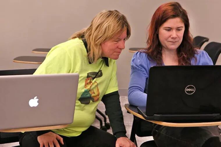 LeAnne Lis, left, works with Jenny Gibbons at CoderGirl, a meetup sponsored by LaunchCode, for women who are interested in programming on November 19, 2014, in St. Louis. (Cristina Fletes-Boutte/St. Louis Post-Dispatch/TNS)