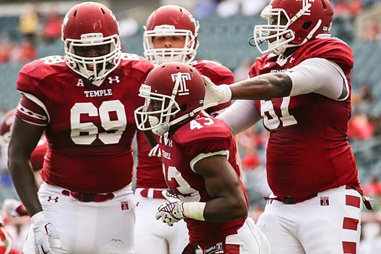Temple players celebrate after running back Hassan Dixon's touchdown run. (Andrew Thayer/Staff Photographer)