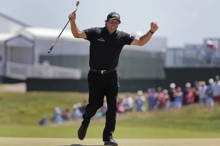 Phil Mickelson reacts after sinking a putt on the 13th hole during the final round of the U.S. Open.