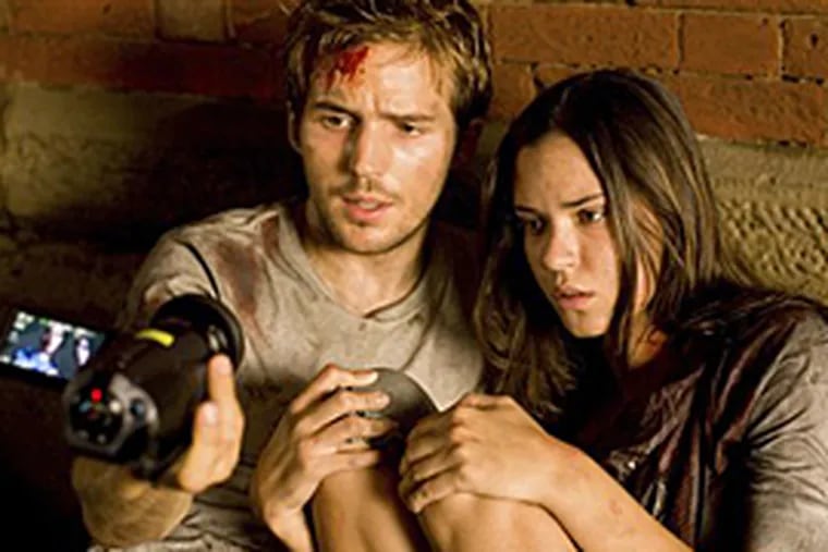 Michael Stahl-David, left, and Odette Yustman, in a scene from "Cloverfield," which apes the viral marketing of "The Blair Witch Project" and rests on the same gimmick.