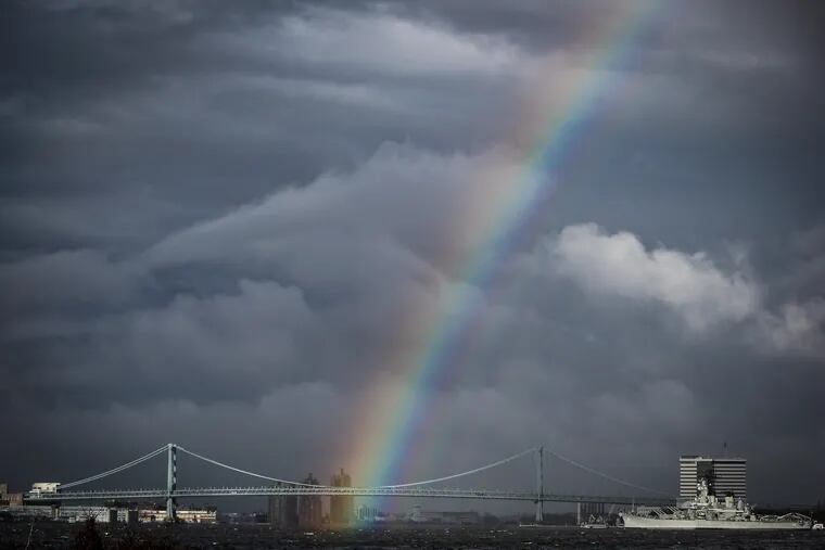 A rainbow appears over the Ben Franklin Bridge after a rain storm earlier in the winter. The forecast holds no pot of gold nor even a silver lining for snow-lovers.