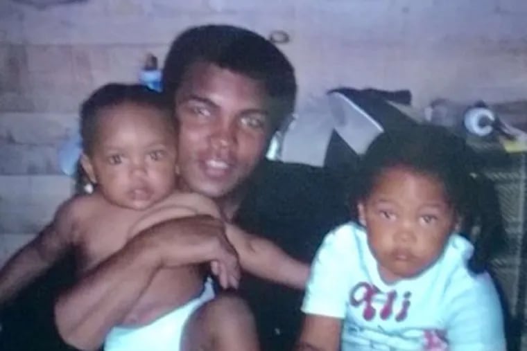 Muhammad Ali holding daughters Hanna (left) and Khaliah.