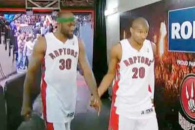 The Web is all a'twitter over Reggie Evans (left) and Leandro Barbosa holding hands after a game. (YouTube)