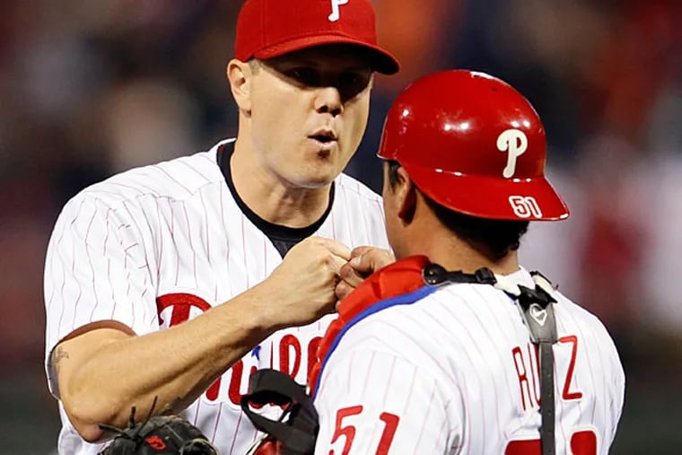 Jonathan Papelbon, left, and catcher Carlos Ruiz celebrate at the end of a baseball game against the Miami Marlins, Friday, April 11, 2014, in Philadelphia. The Phillies won 6-3. (Tom Mihalek/AP)