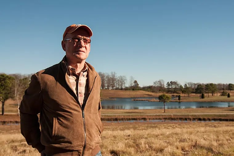 Henry McNiel, who is selling land to Winslow township, stands infront of the lake he crafted over the years. McNiel took the purchasing parties on a tour of his expansive part of Winslow Township NJ. (PATRICK MCPEAK/STAFF PHOTOGRAPHER)