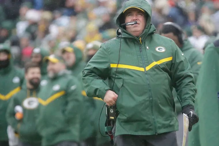 Green Bay Packers' Head Coach Mike McCarthy watches a replay on the scoreboard during the first half of an NFL football game against the Arizona Cardinals Sunday, Dec. 2, 2018, in Green Bay, Wis. (AP Photo/Mike Roemer)