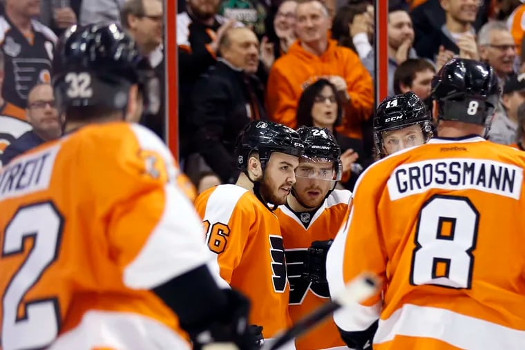 The Flyers' Matt Read celebrates his first period goal with his teammates. (Yong Kim/Staff Photographer)