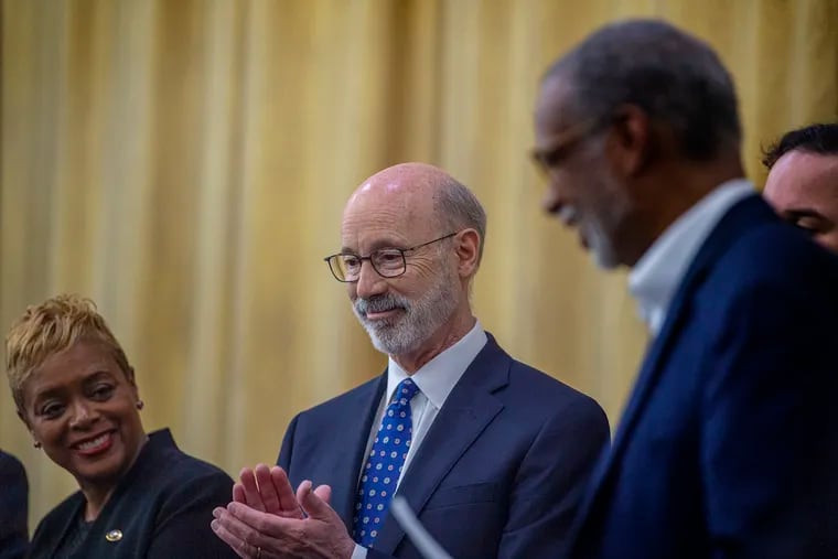 Governor Tom Wolf, talks to school officials on his plans to to funnel more money to struggling districts during a news conference at the Logan Elementary School.