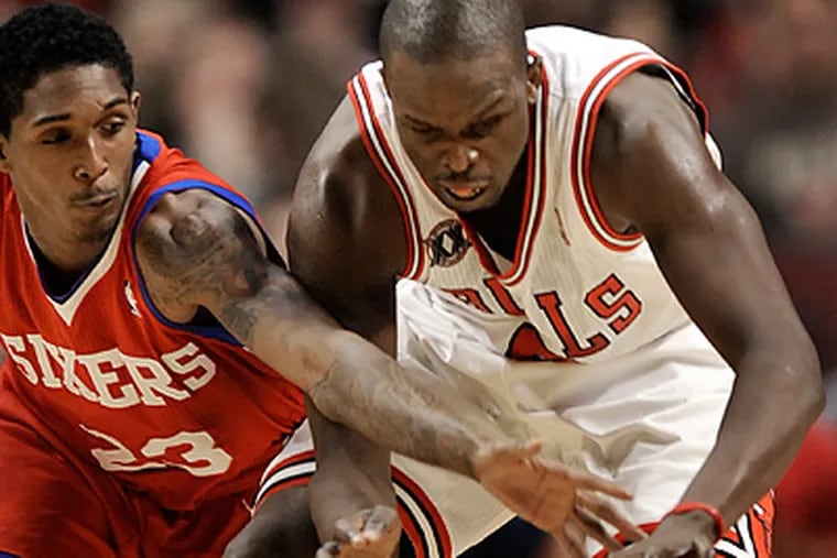 Chicago's Luol Deng vies for a loose ball against Lou Williams in the second quarter. (Paul Beaty/AP)