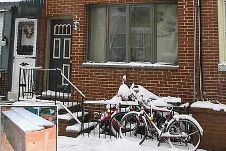 A scooter and two bikes sit outside the rowhouse where police found the victim in a makeshift coffin (inset). The Croskey Street home was an unlicensed boarding house, cops said. (Alejandro A. Alavarez/Staff Photographer)