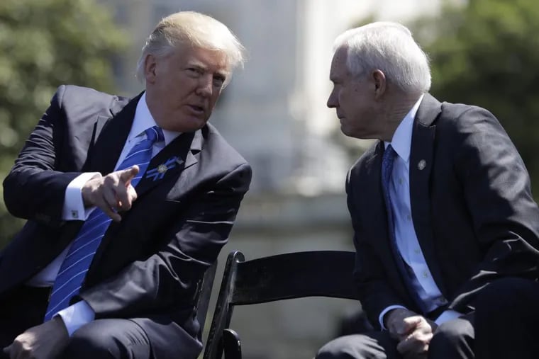 President Donald Trump talks with Attorney General Jeff Sessions before speaking at the 36th Annual National Peace Officers' memorial service last month.