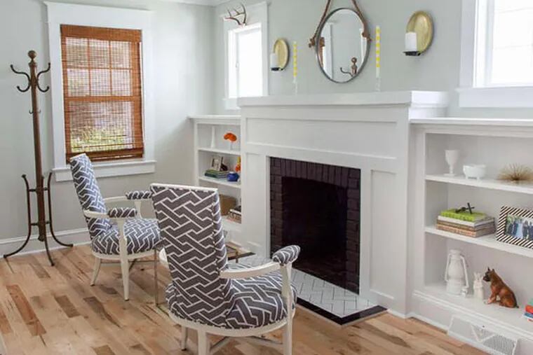 New bookcases and wood surround for the fireplace were installed by Tyler Grace. He also updated the hearth, laying subway tile in a herringbone pattern. (Courtney Apple photo)