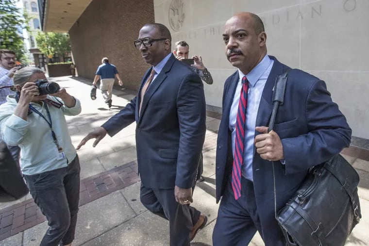 Philadelphia District Attorney Seth Williams, right, leaves federal court on Monday, June 26, 2017.