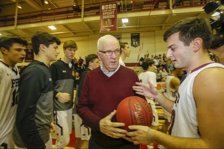 St. Joseph’s Prep coach Speedy Morris receives the game basketball from player Vince Busico after the Prep beat Lansdale Catholic for Morris’ 1,000th career win on Friday, January 12, 2018.