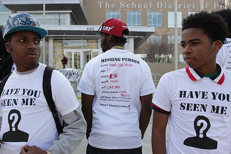 Protesters Andre Simmons, left, Markeith Spencer, center, and Maury Elliott, right, gather as Youth United for Change launch a Missing Persons Campaign during a protest on the steps of the Philadelphia School District on April 8, 2014. ( DAVID MAIALETTI / Staff Photographer )