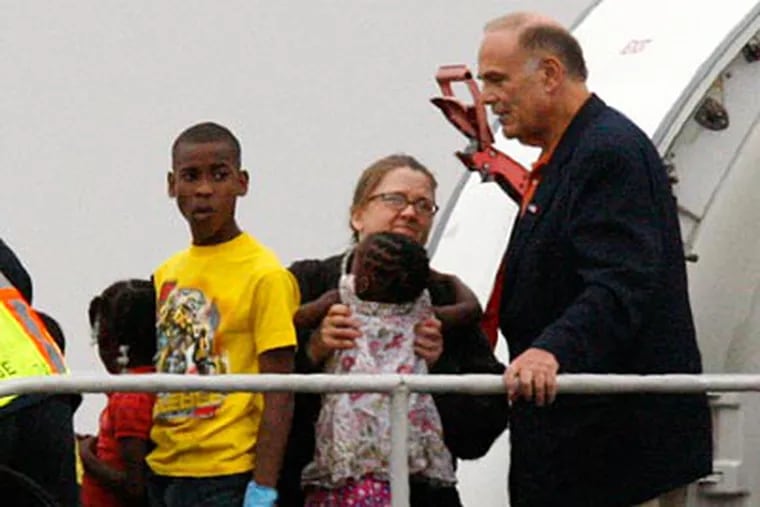 Gov. Ed Rendell arrives on an Air Force plane carrying 53 Haitian orphans at Pittsburgh International Airport Tuesday, Jan 19, 2010. (AP Photo/Gene J. Puskar)