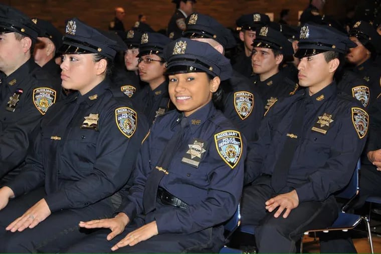New York City Police Department auxiliary officers are shown at a graduation ceremony after training.