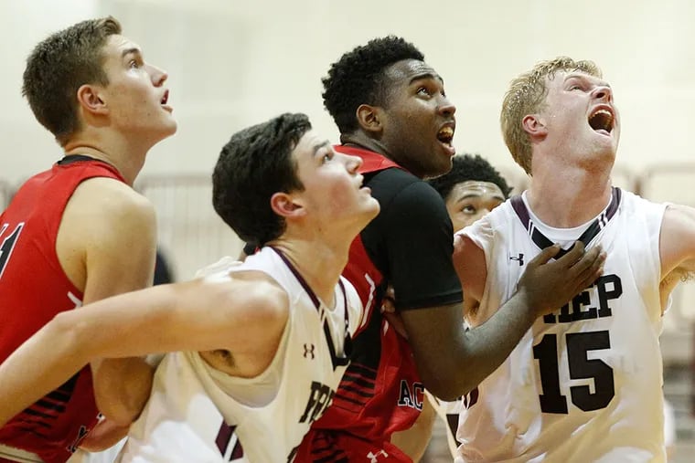 St. Joe's Prep players Chris Montie and Pete Gayhardt battle for rebounding position with Germantown Academy's Kyle McCloskey and Evan-Eric Longino.