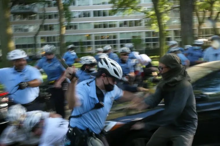 Screengrab of video footage shows police clashing with protesters early Monday evening near the Benjamin Franklin Parkway. Witnesses said the attack seemed unprovoked.