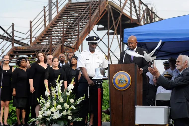 Mayor Michael Nutter watched as one of eight doves, one for each of the Amtrak victims, was released during a service of "reflection" at the derailment site at Frankford Junction May 17, 2015. (TOM GRALISH / Staff Photographer)
