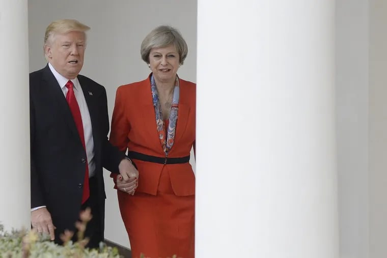 President Donald Trump holds hands with Prime Minister Teresa May as they walk the colonades of the White House on January 27, 2017, in Washington, D.C. (Olivier Douliery/Abaca Press/TNS)
