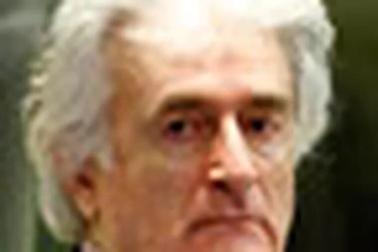 FILE - In this Nov. 3, 2009 file photo former Bosnian Serb leader Radovan Karadzic enters the courtroom of the U.N.'s Yugoslav war crimes tribunal (ICTY) in The Hague, Netherlands. The ICTY has acquitted Karadzic of one of the two genocide charges he faces at the halfway stage of his long-running trial on Thursday, June 28, 2012. Judges say prosecutors did not present enough evidence to support the genocide count covering mass killings, expulsions and persecution by Serb forces of Muslims and Croats from Bosnian towns early in the country's 1992-95 war. (AP Photo/Michael Kooren/Pool, File)