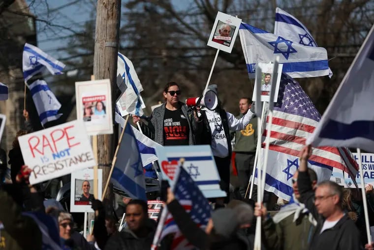 A group of protesters in support of Israel stand on Montgomery Ave. as protesters in support of Palestine, mainly from Haverford College, march by in Ardmore, Pa. on Saturday, Feb. 24, 2024.