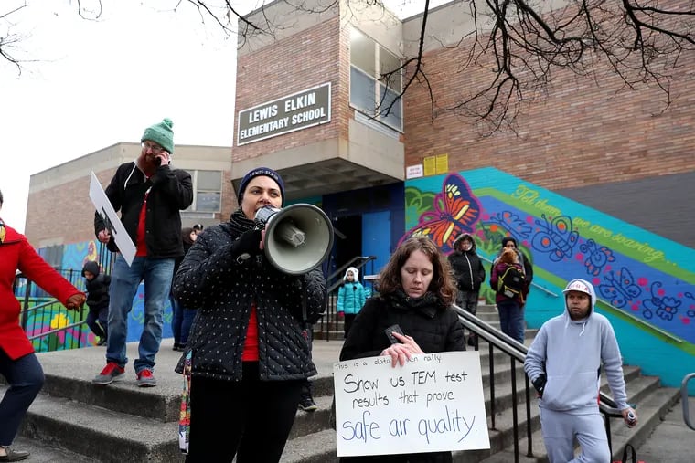 Teachers Cristina Gutierrez, left, and Teresa Kelley Rugerio, right,  join fellow teachers in protesting outside their school, Lewis Elkin Elementary in Philadelphia on Monday, Jan. 27, 2020. The teachers were refusing to enter the building because of asbestos issues. Some parents also declined to send their children to school.