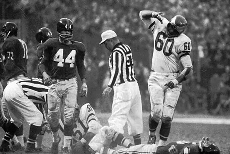 Chuck Bednarik stands over a laid out Frank Gifford. (File photo)