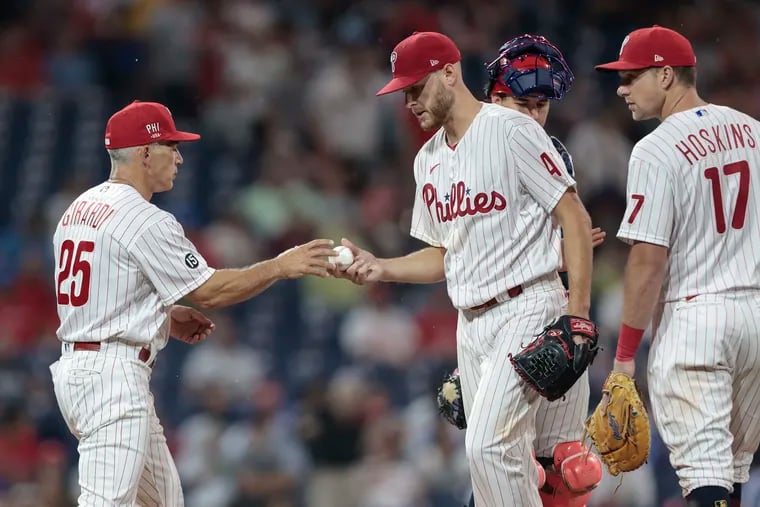 Phillies pitcher Zack Wheeler hands the ball to manager Joe Girardi after throwing 7 2/3 shutout innings against San Diego Friday night.