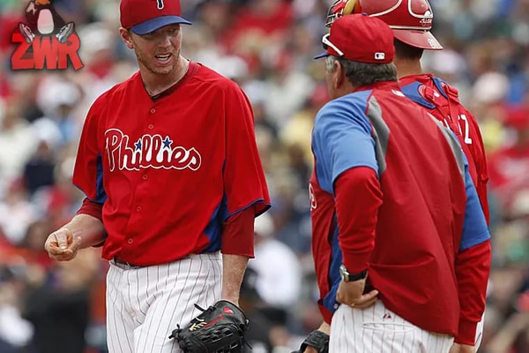 Phillies starting pitcher Roy Halladay talks with pitching coach Rich Dubee. (David Maialetti/Staff Photographer)