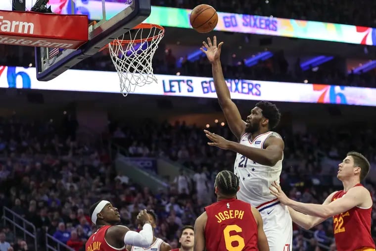 Joel Embiid lays in a shot during the first quarter of the Sixers' win on Sunday, his first game back since the All-Star break.